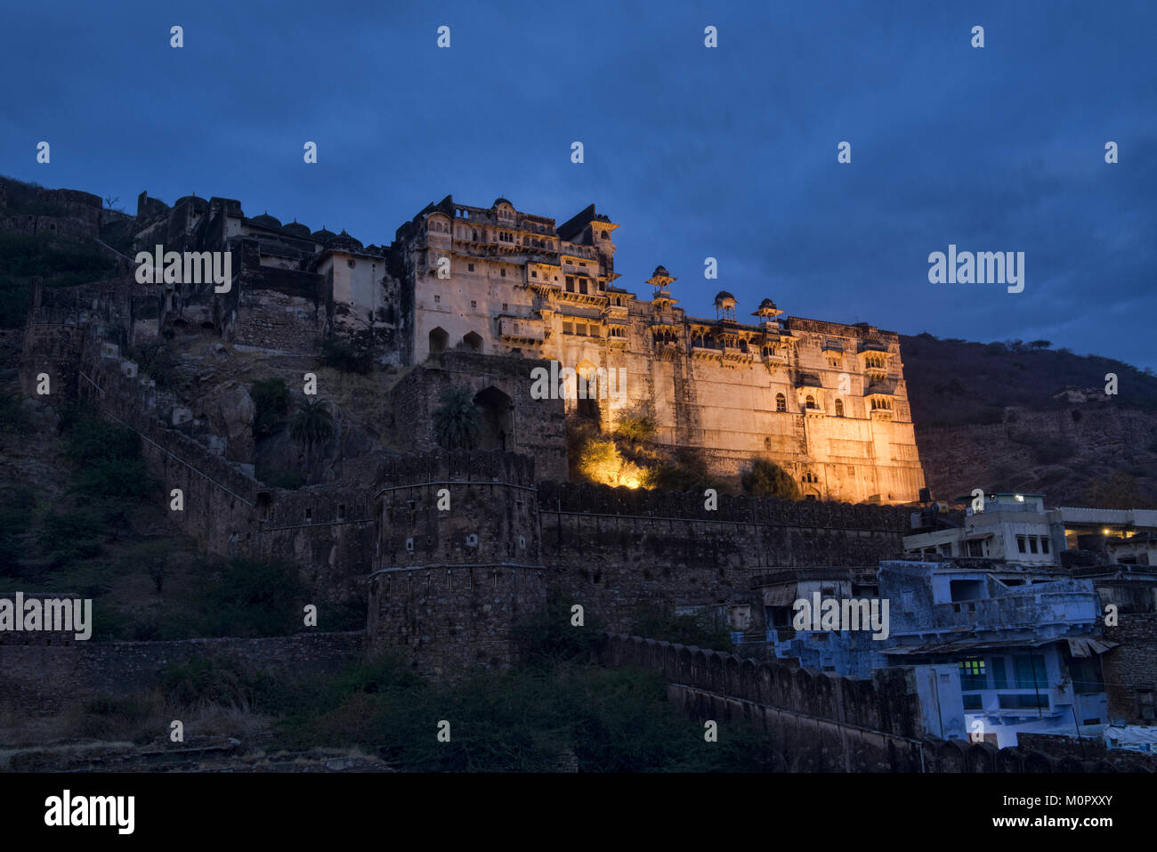 The atmospheric ruined Bundi Palace and Taragarh Fort at night, Rajasthan, India Stock Photo