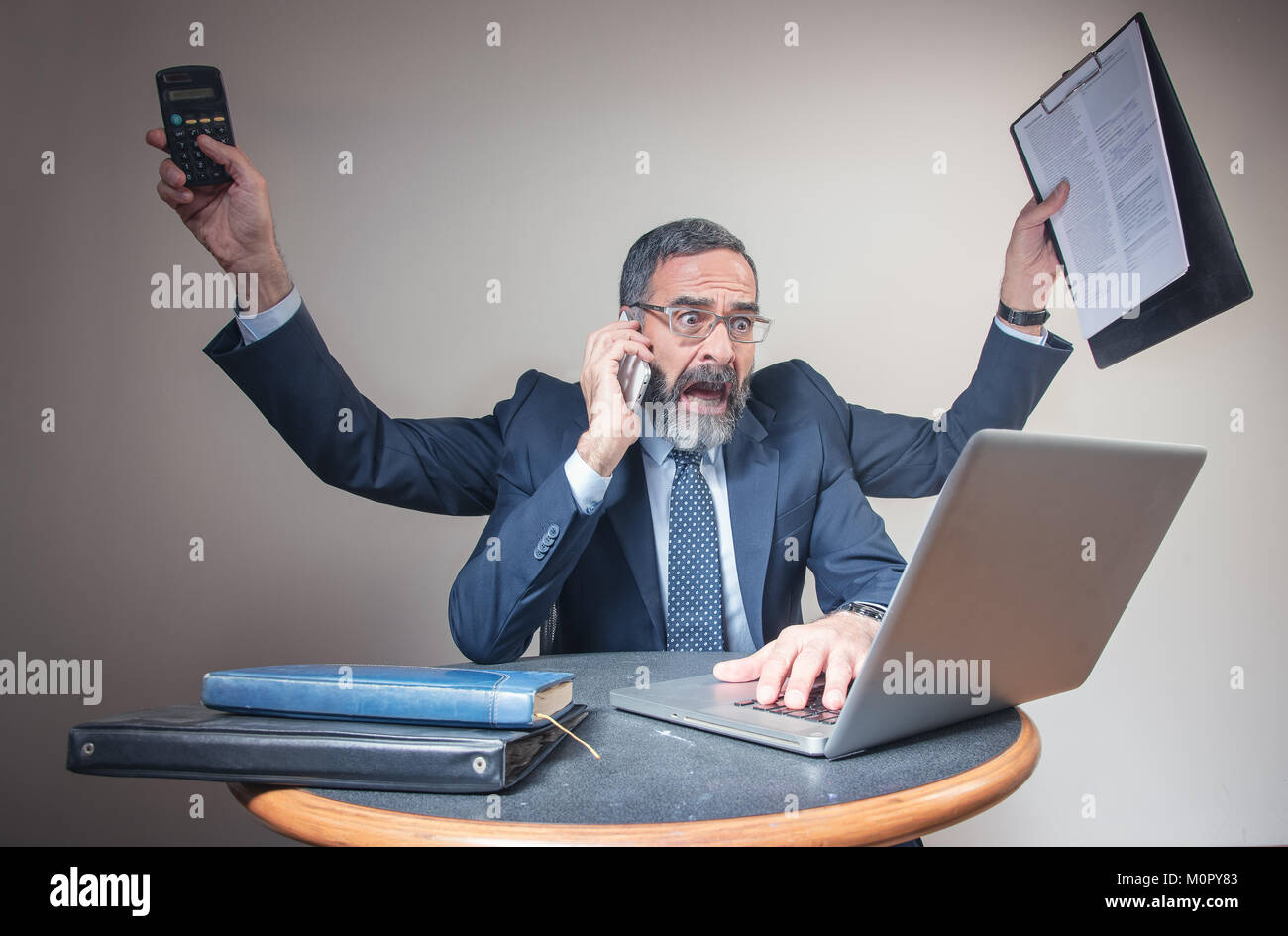 Pressured businessman multitasking, business concept and urban lifestyle Stock Photo