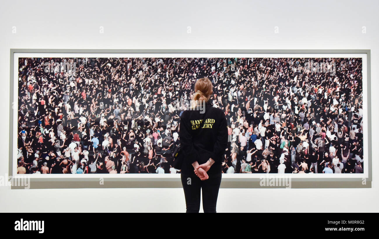 London, UK. 24 January 2018. A staff member views "May Day IV", 2000,  remastered 2014, by Andreas Gursky. Preview of "Andreas Gursky", the first  major UK retrospective by the acclaimed German photographer