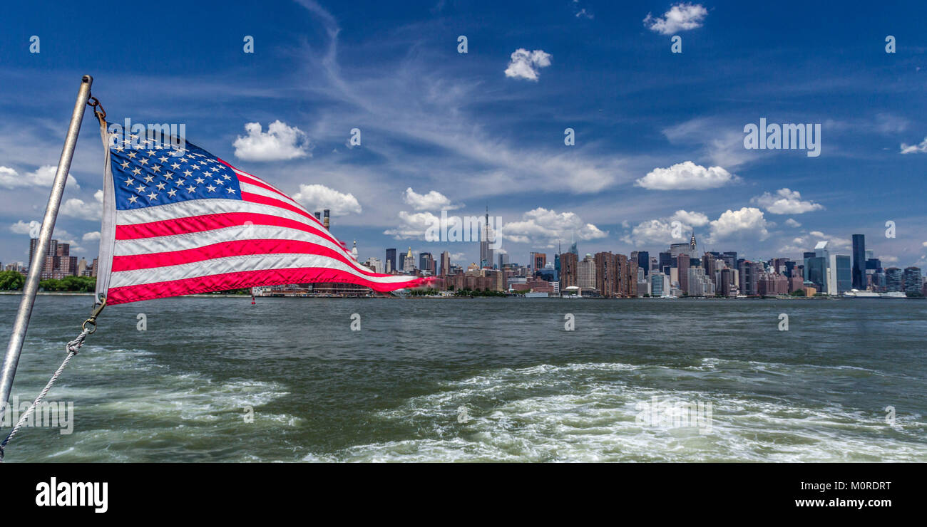 East River Ferry, American Flag, View to Midtown Manhattan, New York Stock Photo
