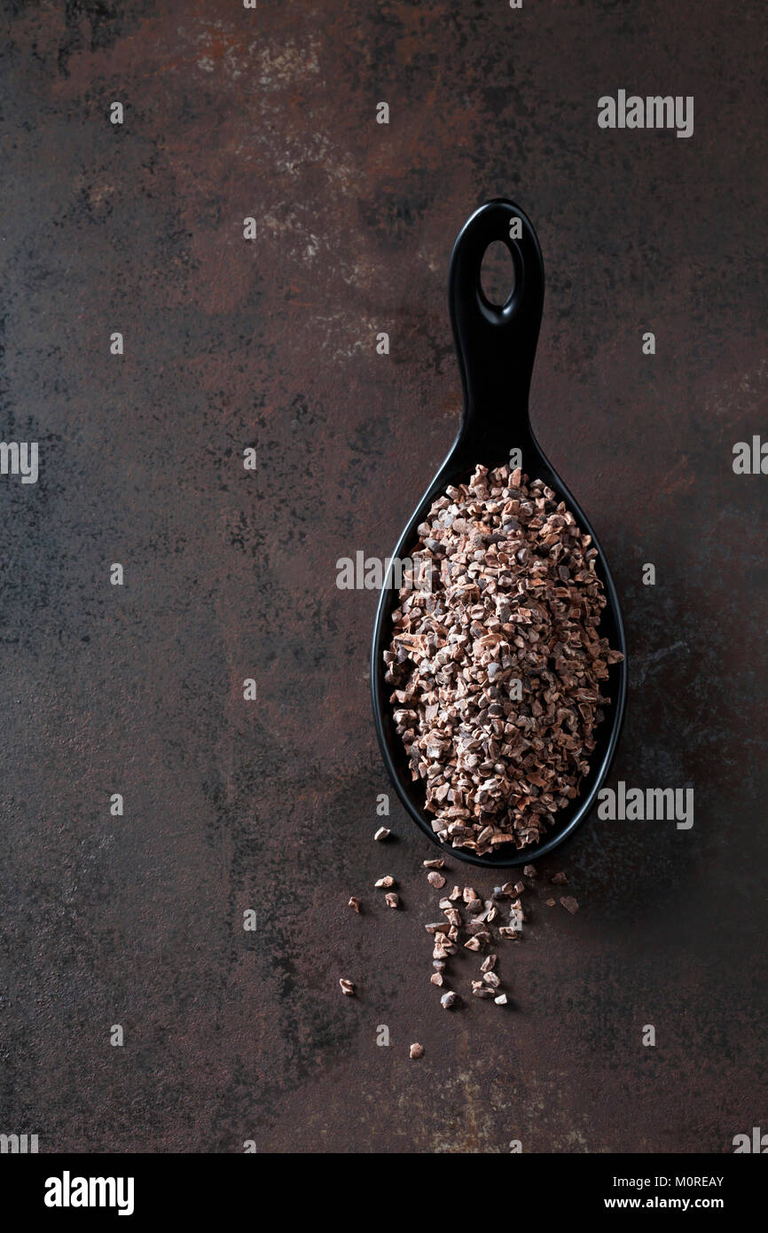 Spoon of crushed raw cacao nibs on rusty metal Stock Photo Alamy