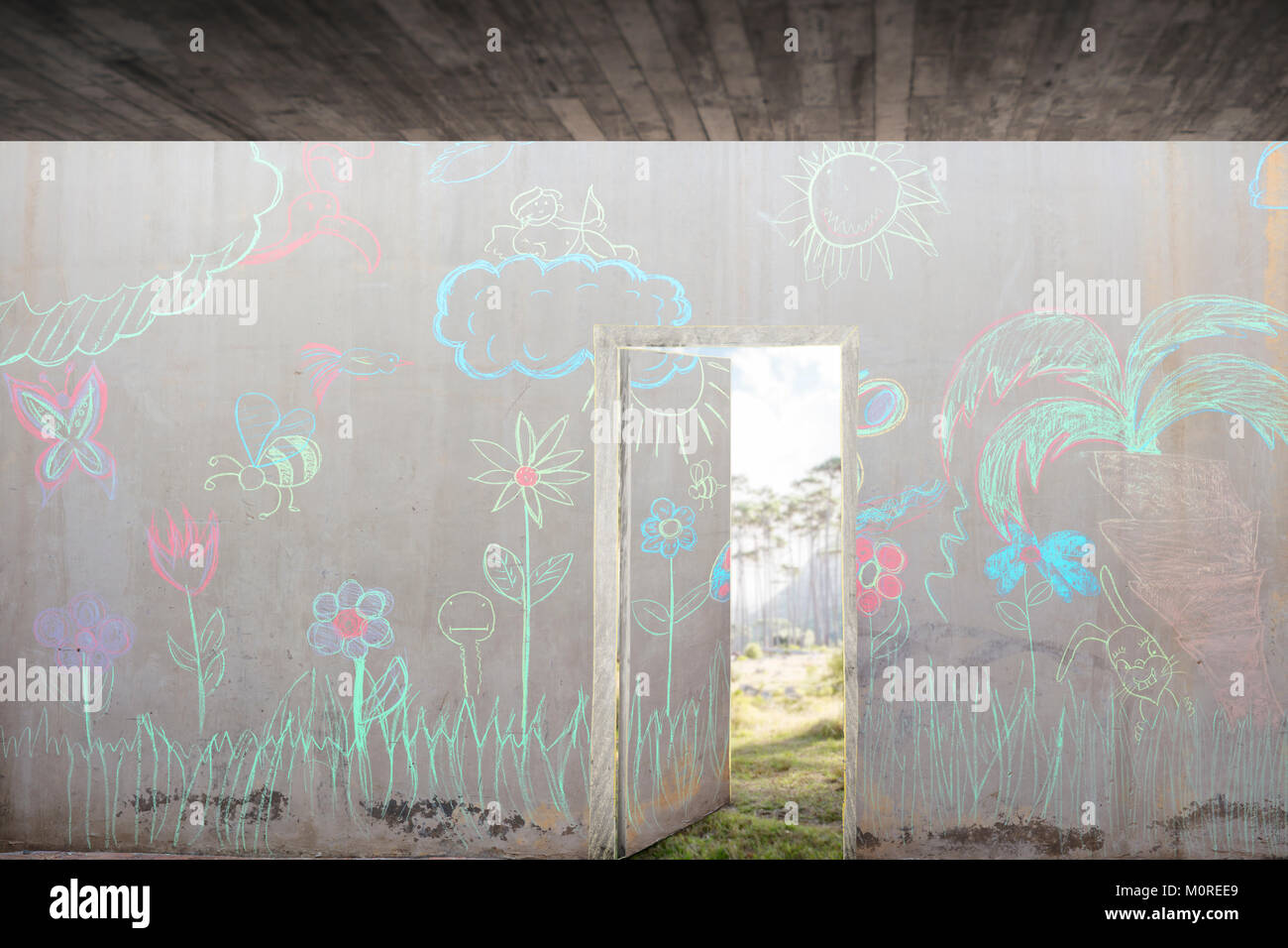 Concrete wall with colourful chalk drawings and open door Stock Photo