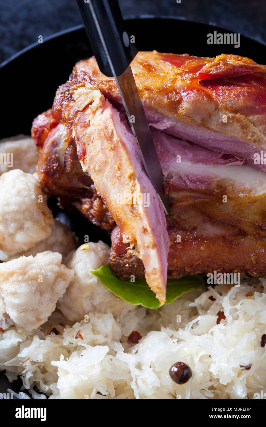 Sliced knuckle of pork with bread dumplings and sauerkraut hires stock