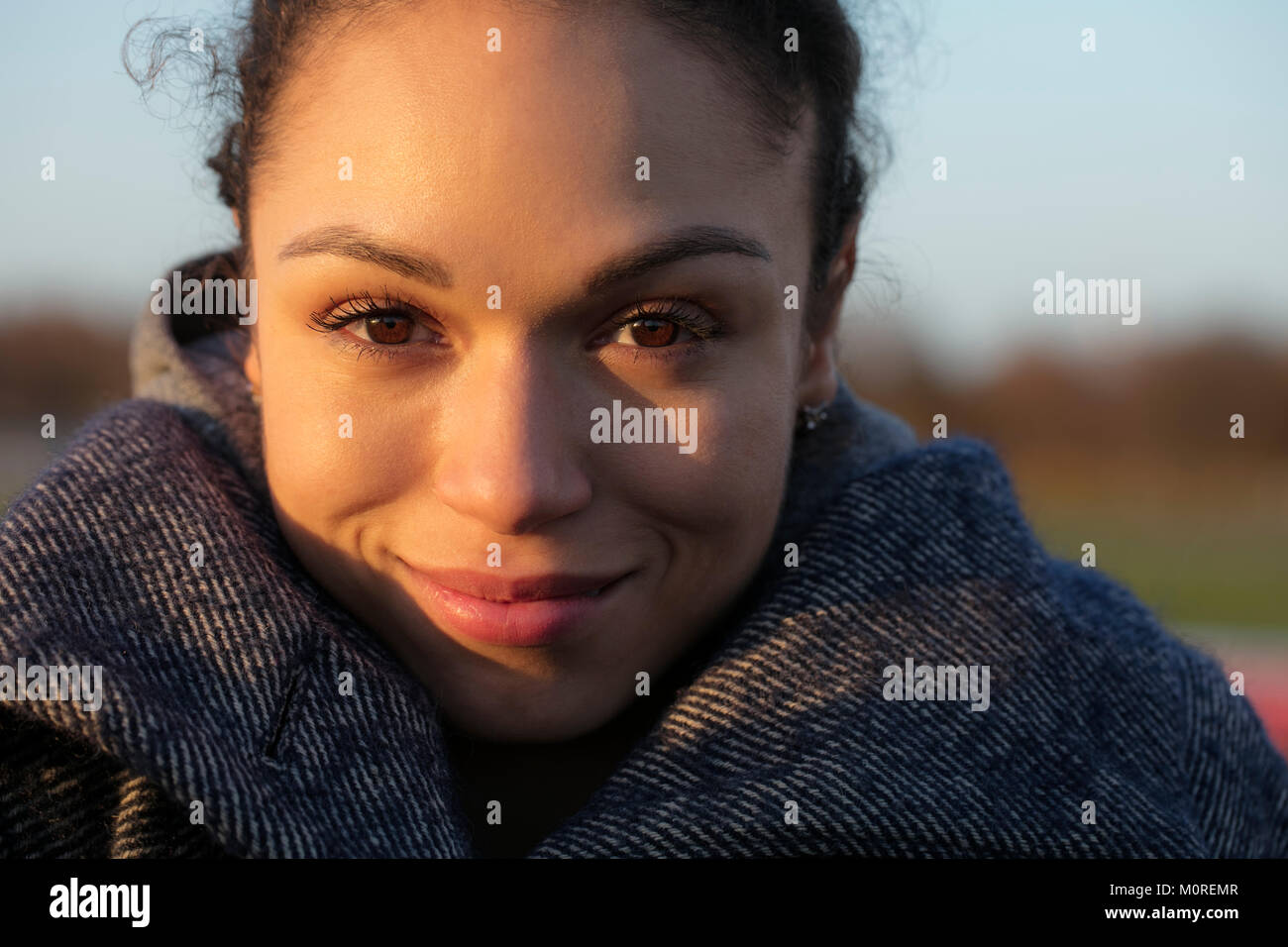 Portrait of smiling young woman outdoors Stock Photo - Alamy