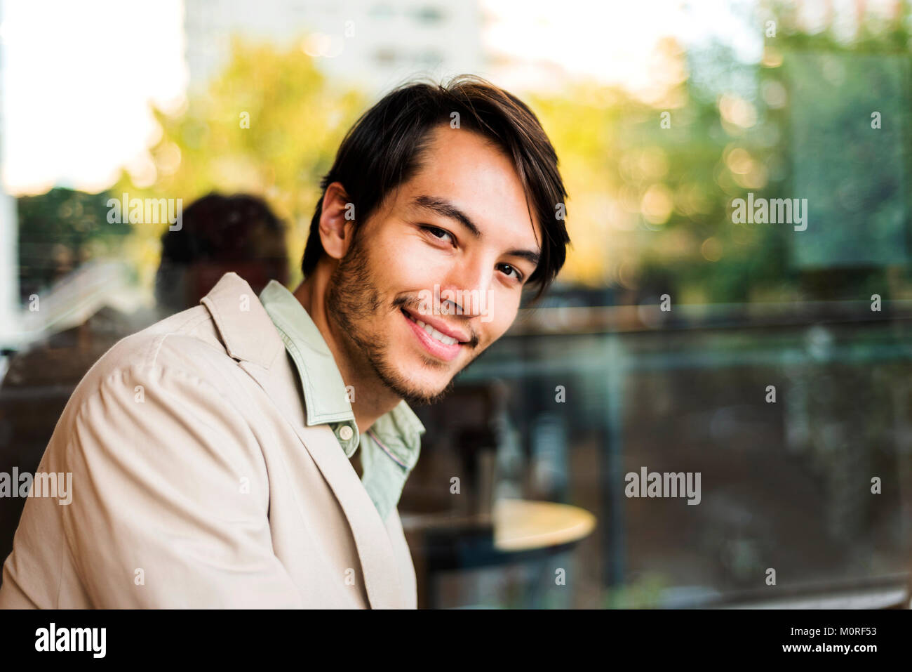 Portrait of smiling young man outdoors Stock Photo - Alamy