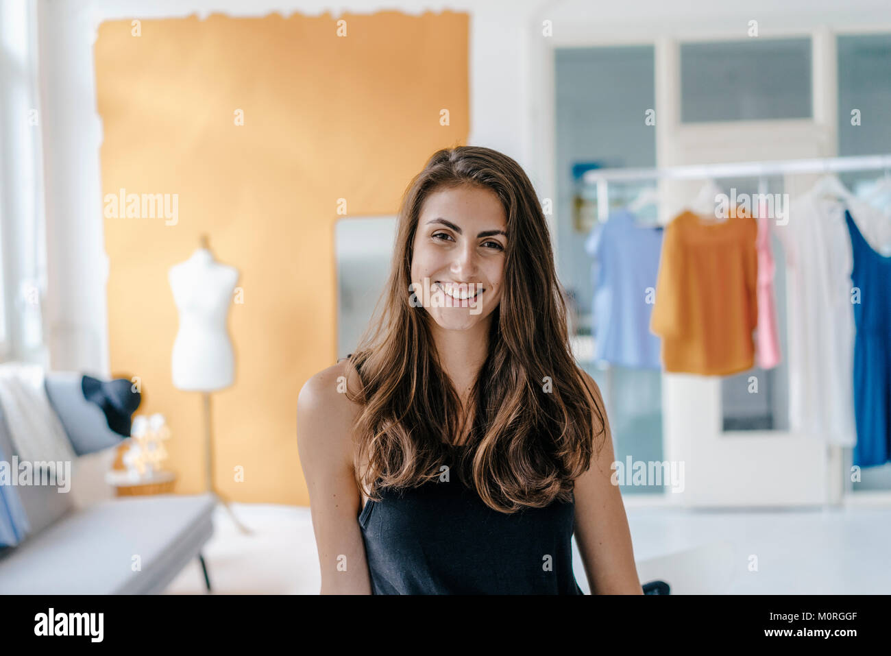 Portrait of happy young woman in fashion studio Stock Photo - Alamy