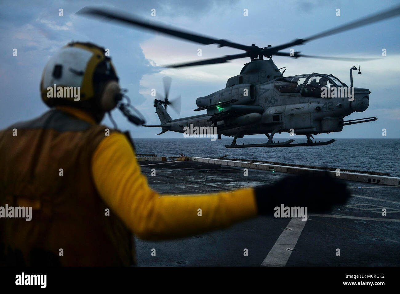 INDIAN OCEAN (Dec. 30, 2017) Aviation Boatswain Mate Handling Airman Ryan Sharland, from Newport Beach, Calif., directs a AH-1Z Viper attack helicopter, attached to Marine Medium Tiltrotor Squadron (VMM) 161 (reinforced), on the flight deck of the amphibious transport dock ship USS San Diego (LPD 22). San Diego, part of the America Amphibious Ready Group, with embarked 15th MEU, is operating in the Indo-Asia-Pacific region to strengthen partnerships and serve as a ready-response force for any type of contingency. (U.S. Navy Stock Photo