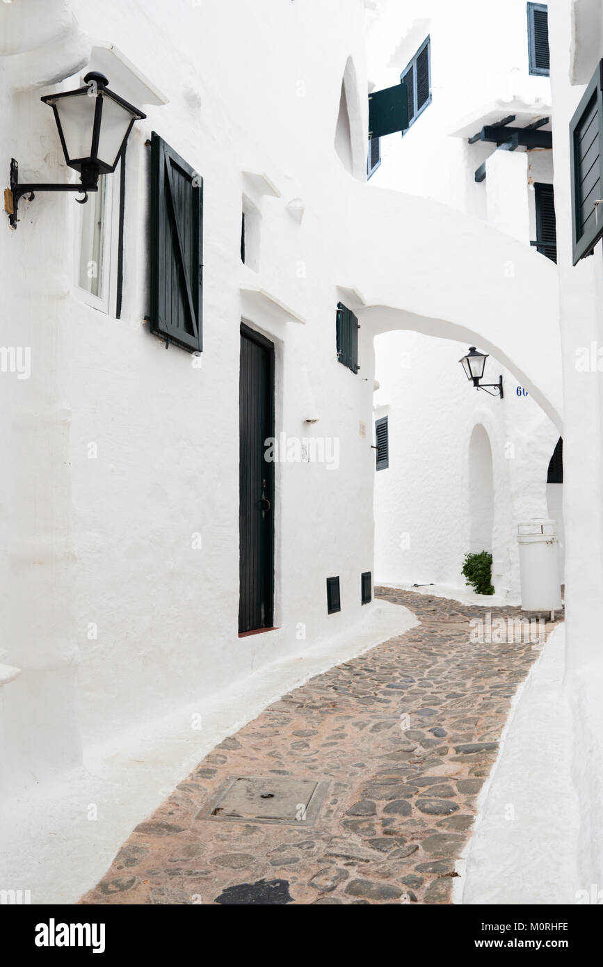 Narrow street in the white traditional small village Binibequer Vell located in Menorca, Balearic Islands, Spain. Stock Photo