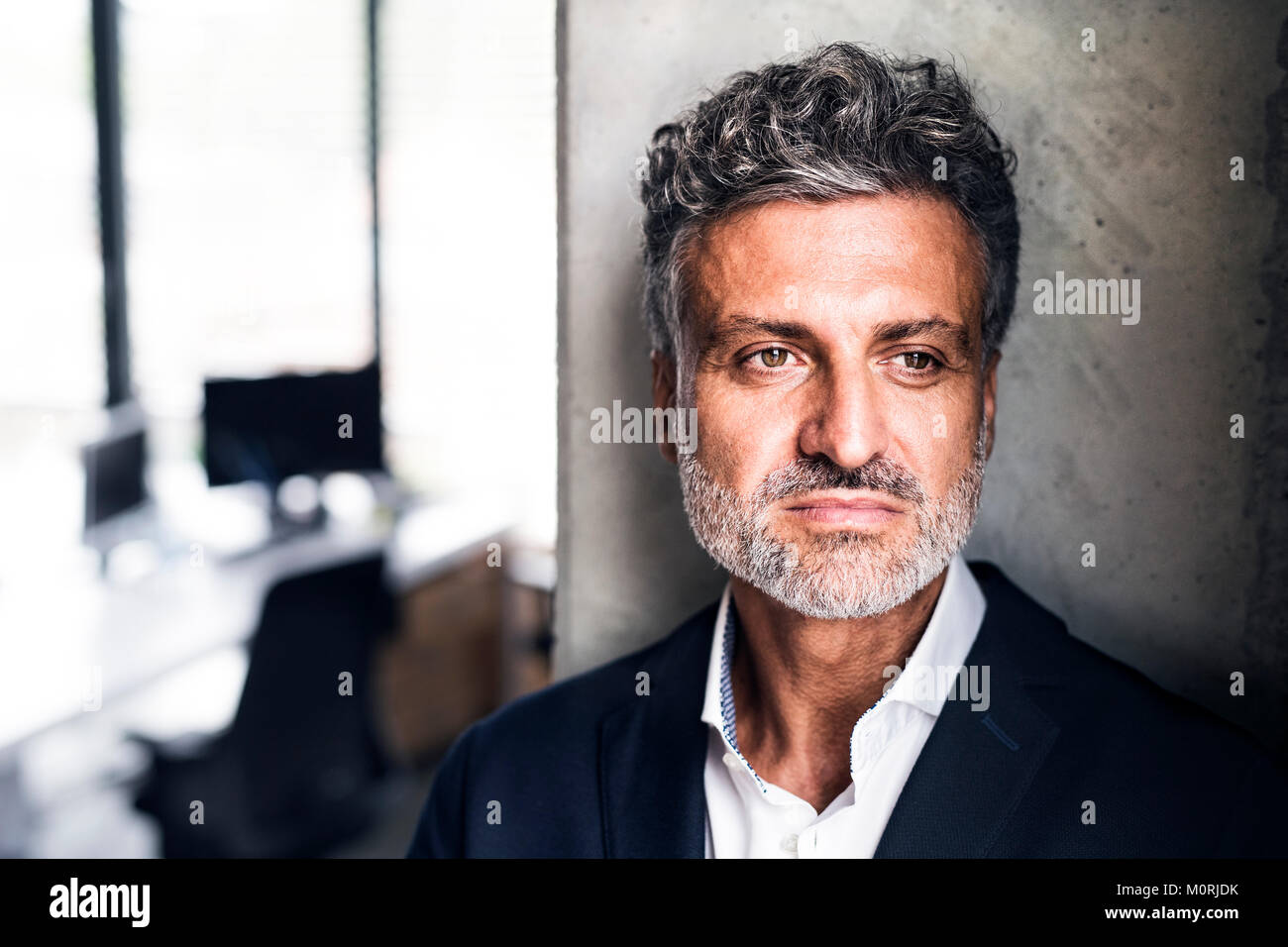 Portrait of mature businessman in office Stock Photo - Alamy