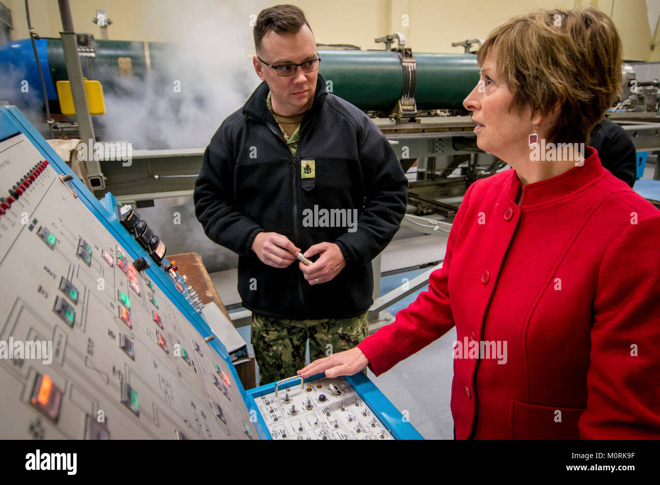 BANGOR, Wash. (Jan. 18, 2018) - Chief Petty Officer Machinist's Mate (SS) John Livingston, assigned to the Trident Training Facility(TTF), shows Mrs. Laura Hyten, wife of Gen. John Hyten, commander of U.S. Strategic Command, how to test equipment in the torpedo lab at the TTF at Naval Base Kitsap-Bangor, Wash., Jan. 18, 2018. Gen. and Mrs. Hyten visited staff and facilities assigned to Commander Submarine Group 9 at Naval Base Kitsap-Bangor to see the operations of one leg of the nuclear triad. (U.S. Navy Stock Photo