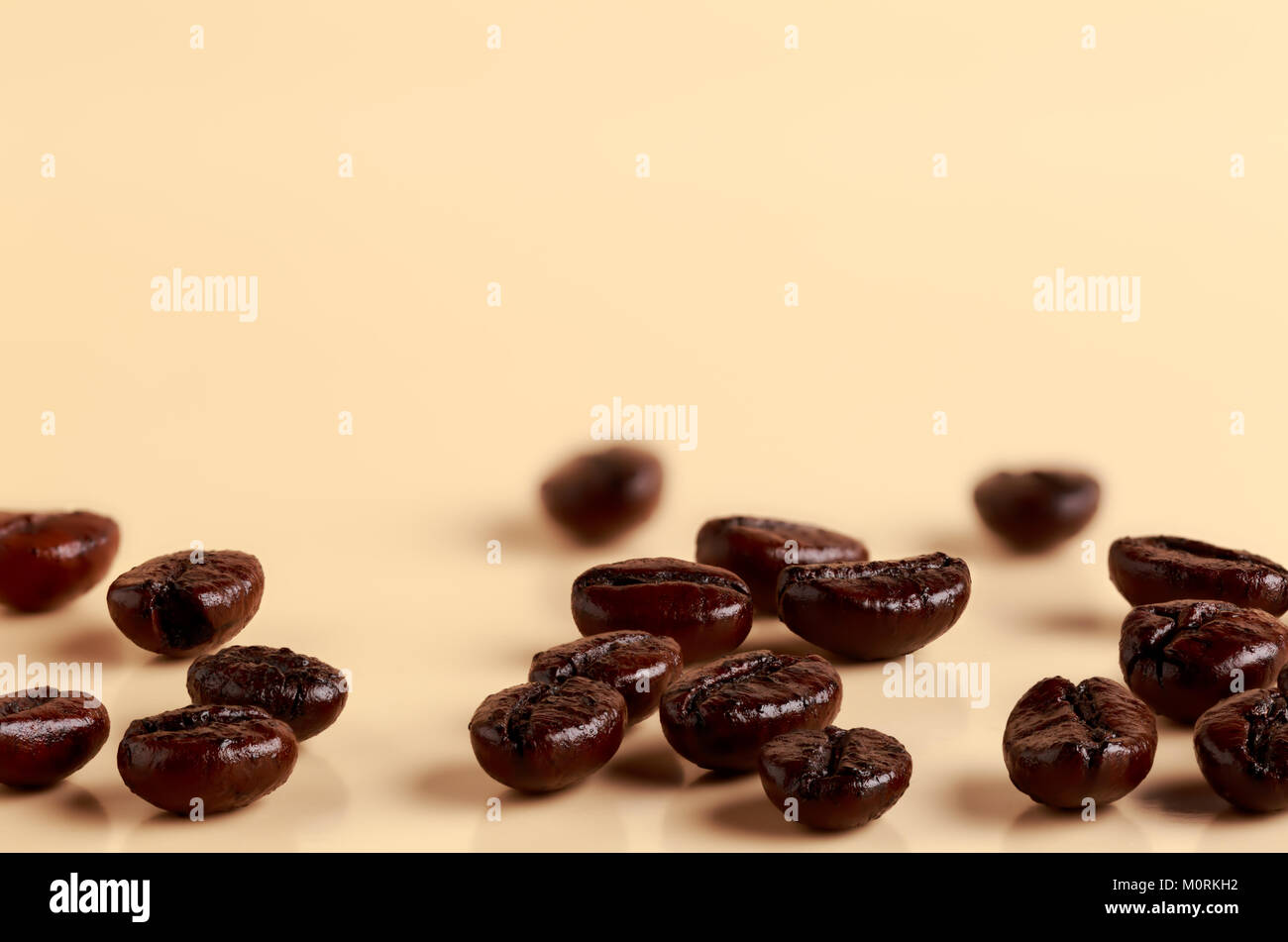 Roasted fresh coffee beans on a bright background Stock Photo - Alamy