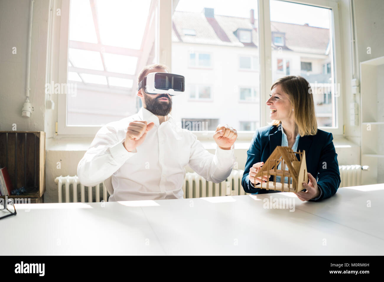 Woman and man with house model and VR glasses in office Stock Photo