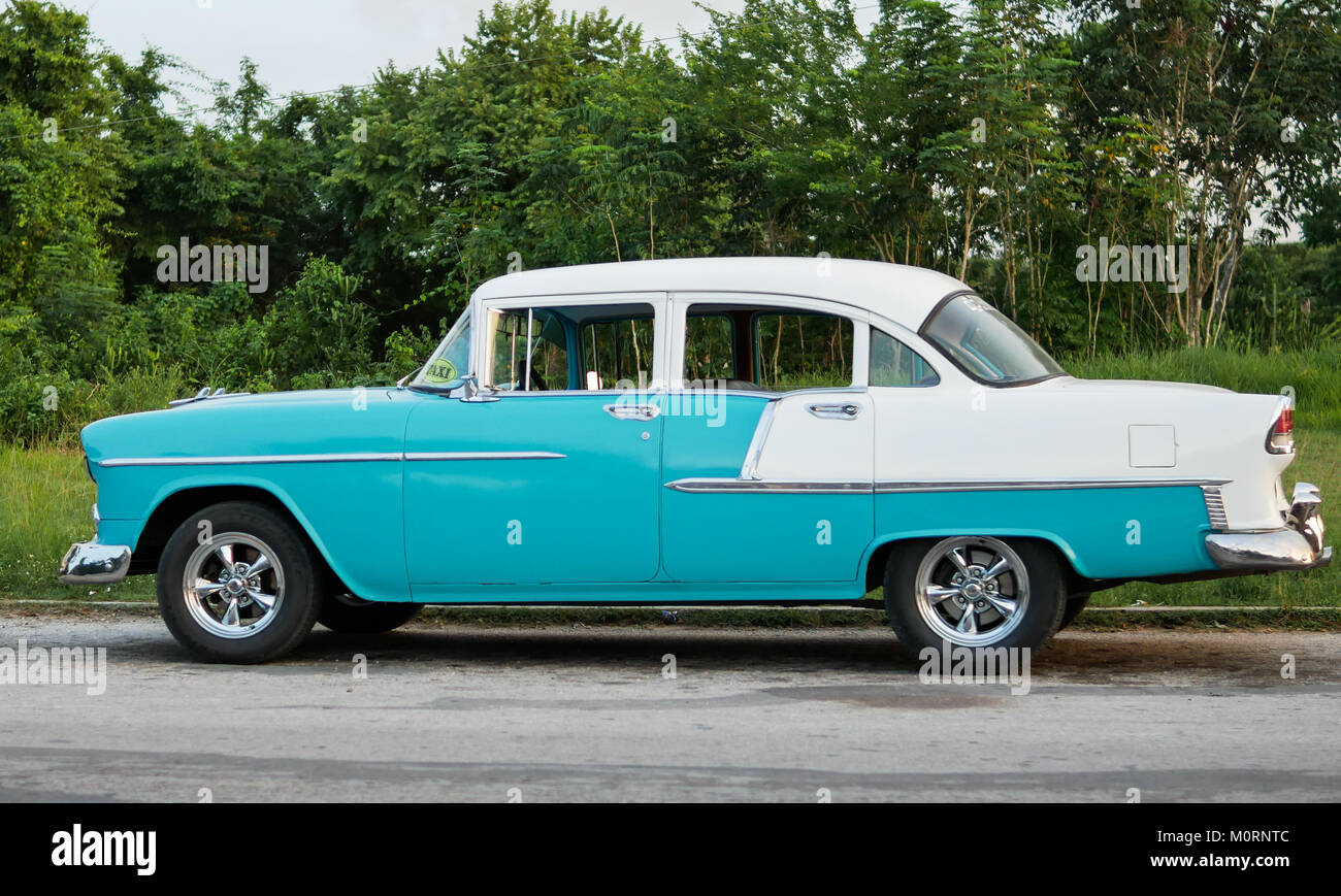 Cuba - September 2017: Classic vintage car taxi parked on street. Stock Photo