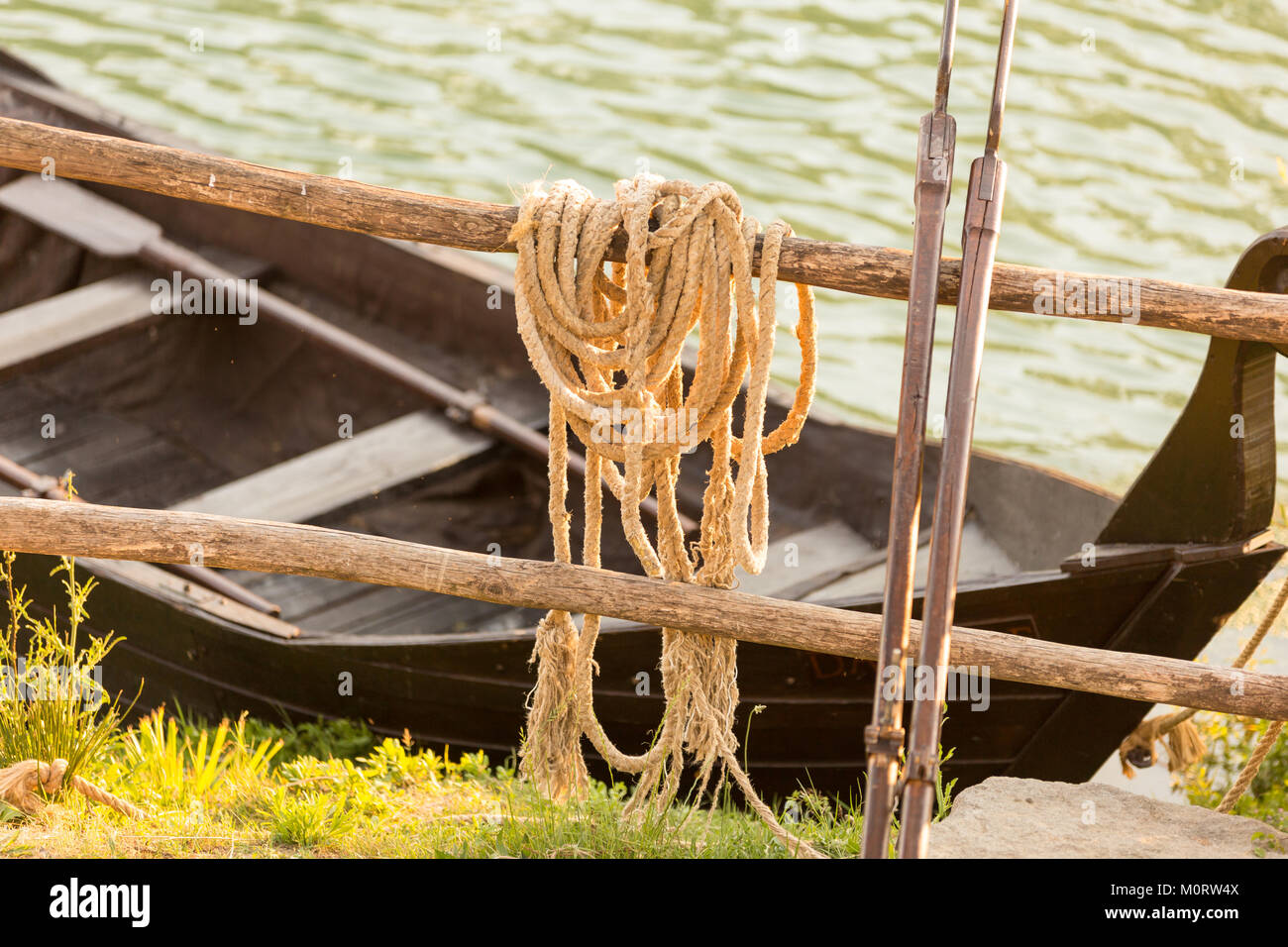 Resting Ropes Fishing rope resting on a fence with a rowboat behind it Stock Photo ...