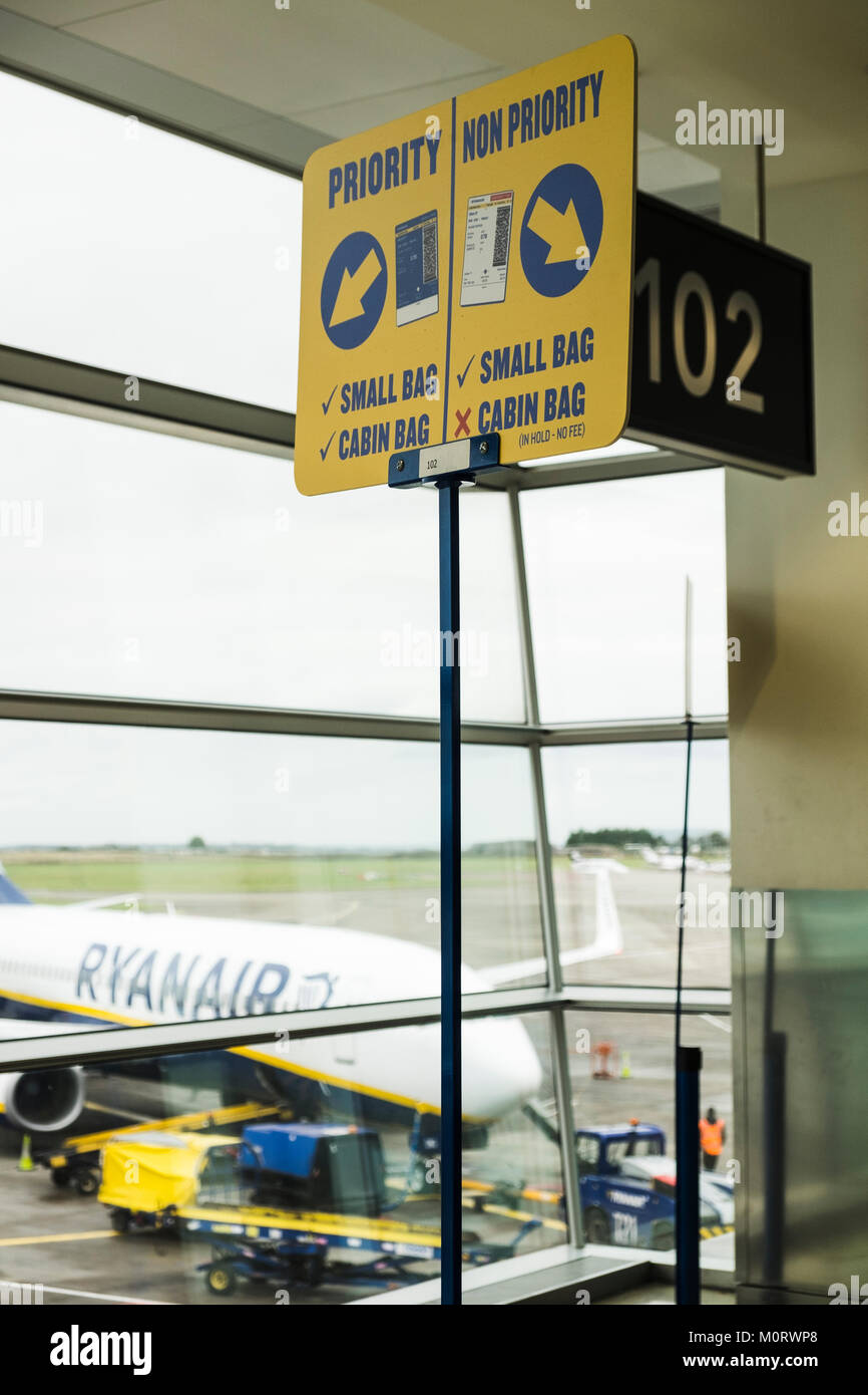 New Ryanair signage with the categories for boarding with cabin baggage, priority, non priority, cabin bags, restrictions, at departure gates in Dubli Stock Photo