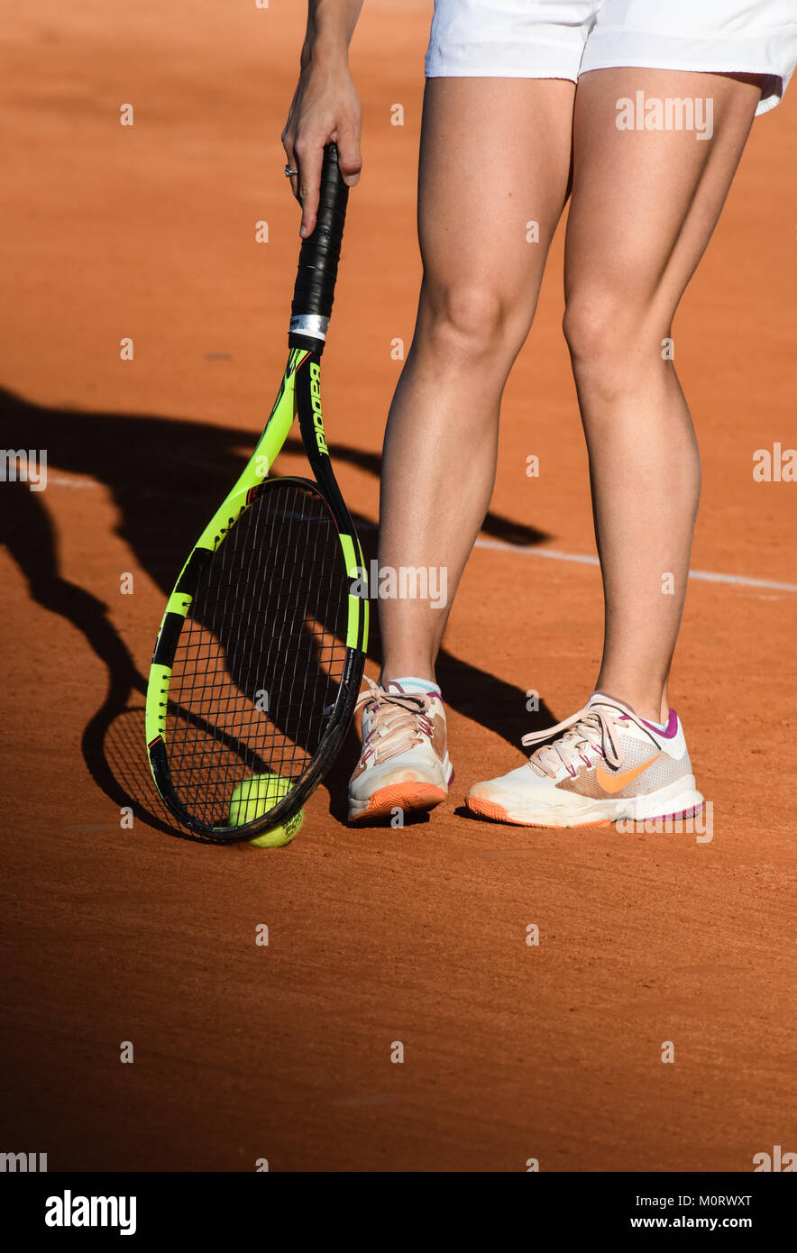 images of details of a women's tennis match, a tennis player hits the