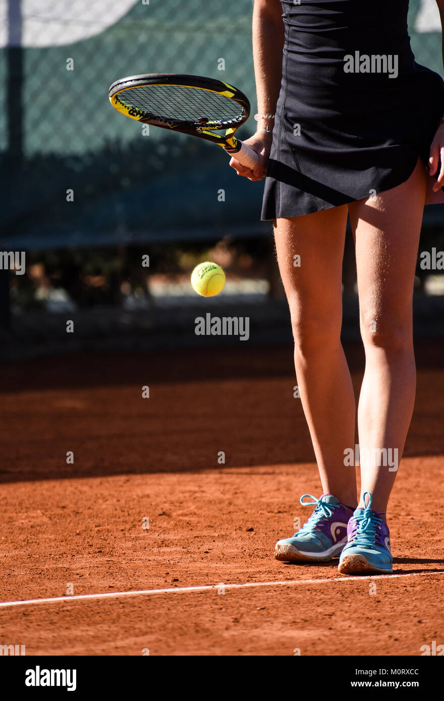 images of details of a women's tennis match,a tennis player prepares to