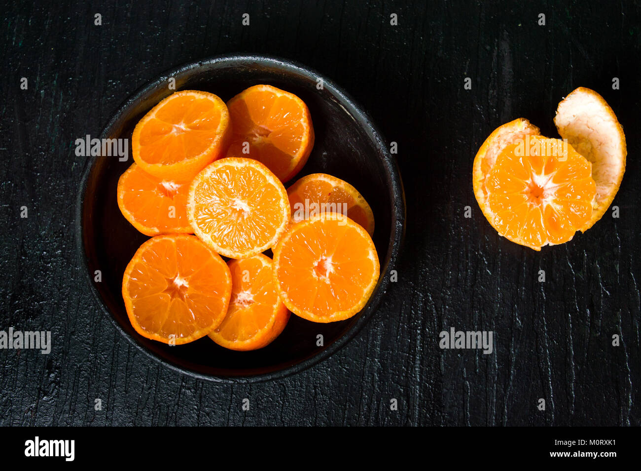 Sliced tangerine fruits in a bowl top view Stock Photo Alamy