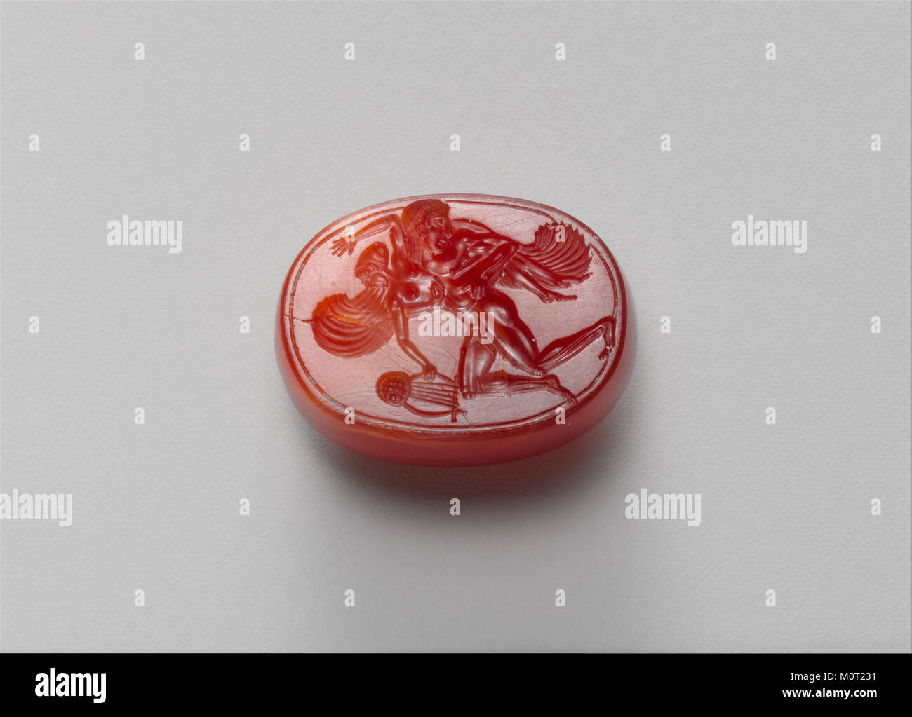 This carnelian scaraboid, part of the collection at the Metropolitan Museum of Art, is an ancient gem carved into the shape of a scarab. It dates back to ancient Egypt and reflects the artistic traditions of the time. Stock Photo