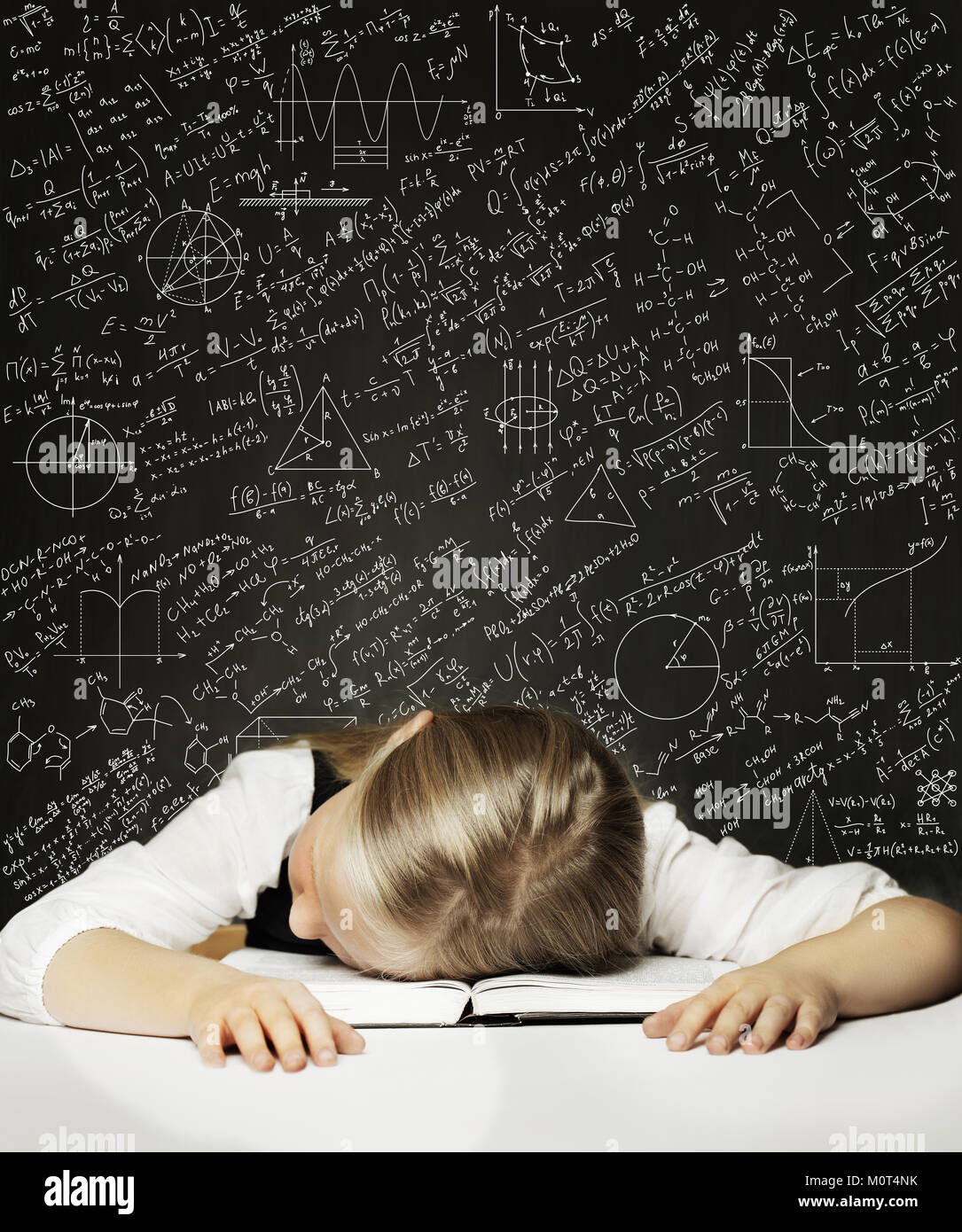 Tired Schoolgirl on the Blackboard Background Stock Photo
