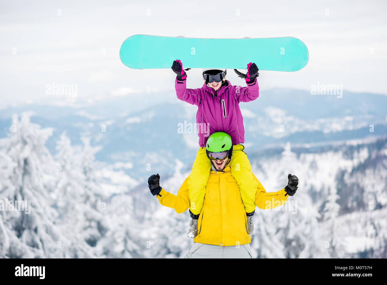 Couple in sports clothes during the winter vacation on the mountains Stock Photo