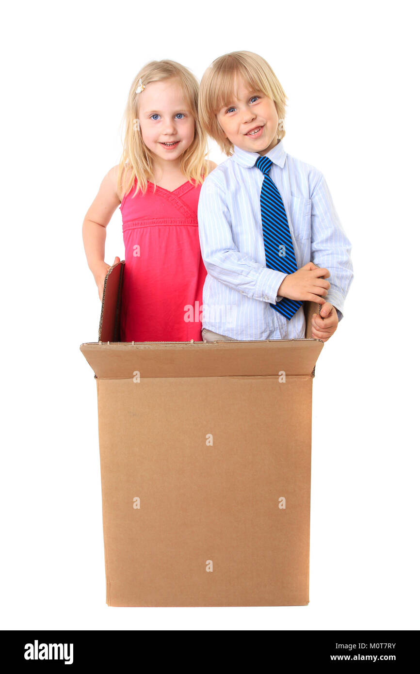 Joyful children look out from a cardboard box. Surprise. Isolated on white background. Series Stock Photo