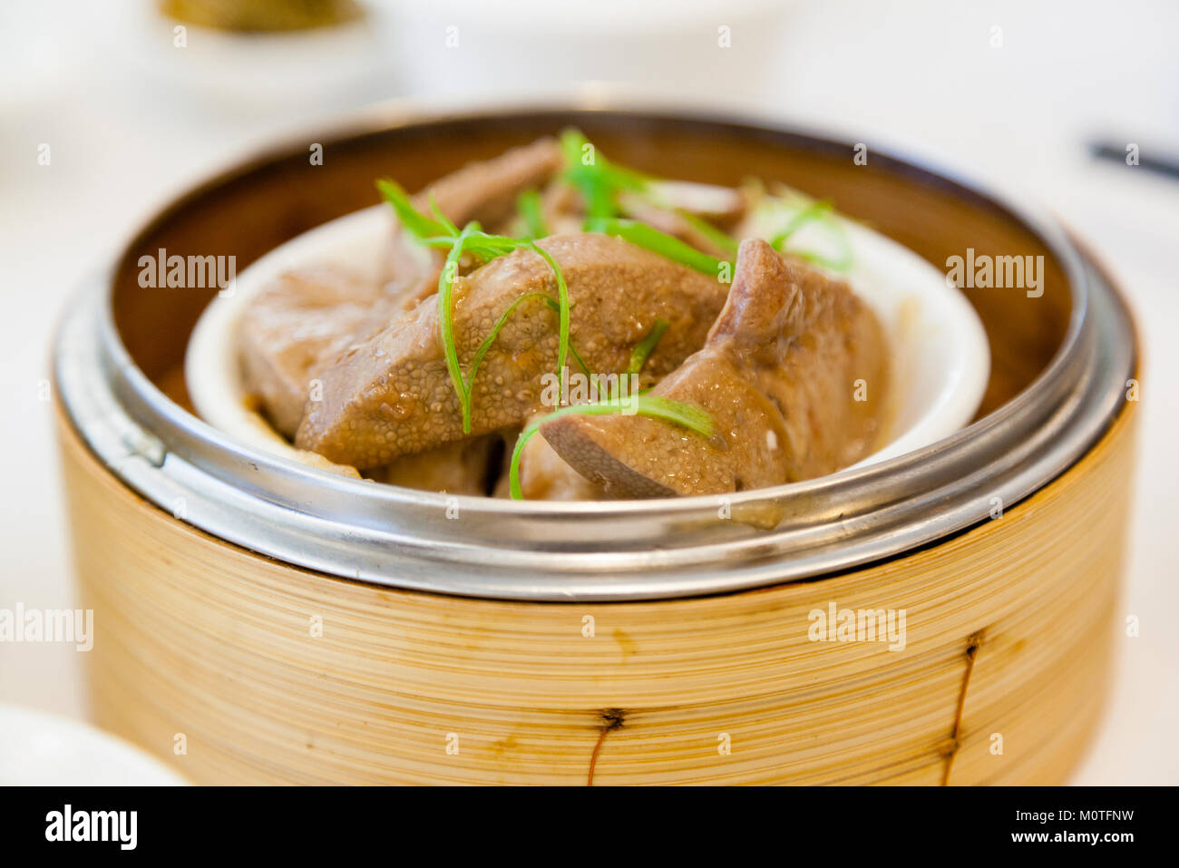 Braised pork liver dim sum in bamboo steamer is a popular dish in Cantonese restaurants in Hong Kong. Stock Photo