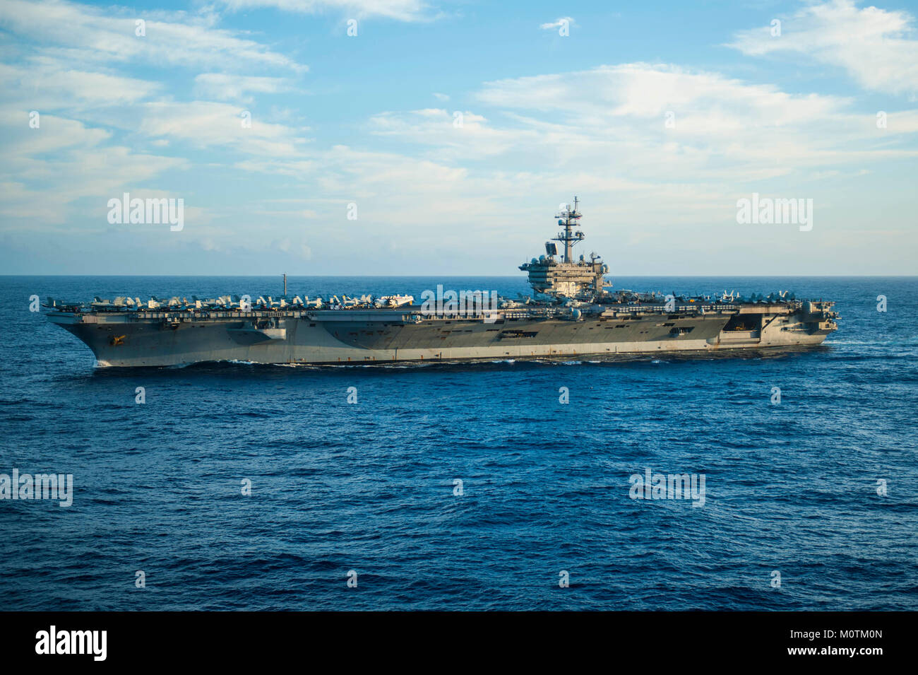 The nuclear-powered aircraft carrier USS Carl Vinson (CVN 70) steams through the Pacific Ocean. The amphibious assault ship USS America (LHA 6) is part of the America Amphibious Ready Group, with embarked 15th Marine Expeditionary Unit (MEU). Stock Photo