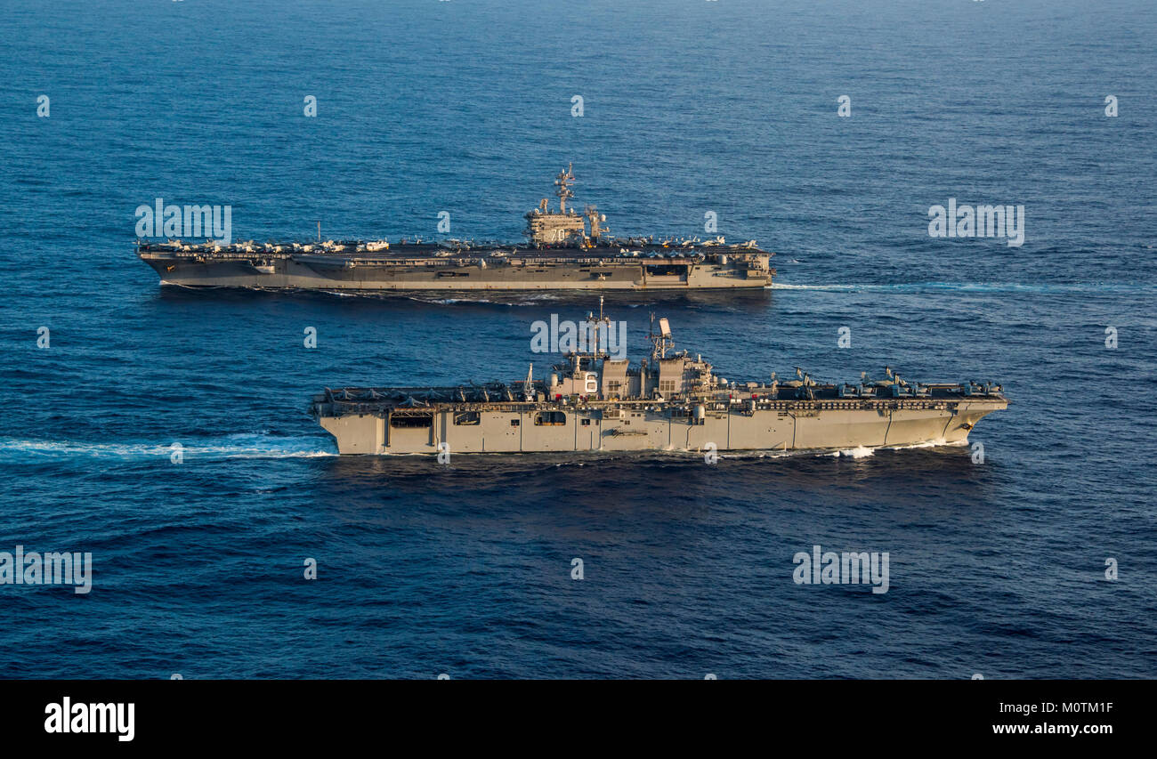 The Amphibious assault ship USS America (LHA 6), foreground, transits the Pacific Ocean next to the Nimitz-class aircraft carrier USS Carl Vinson (CVN 70). Carl Vinson Strike Group is currently operating in the Pacific as part of a regularly scheduled deployment. Stock Photo