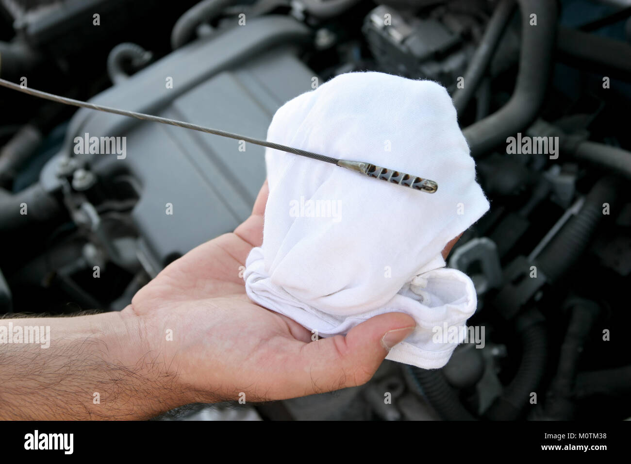 Details checking engine oil dipstick in car Stock Photo Alamy