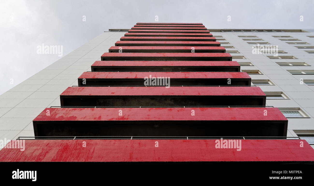 Red old weathered balconies on the facade of an ugly high-rise building, abstract Stock Photo