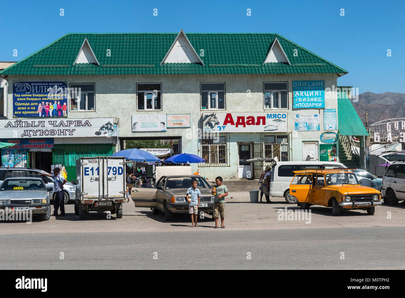 Animation in a street, Kochkor village, Road to Song Kol Lake, Naryn province, Kyrgyzstan, Central Asia Stock Photo