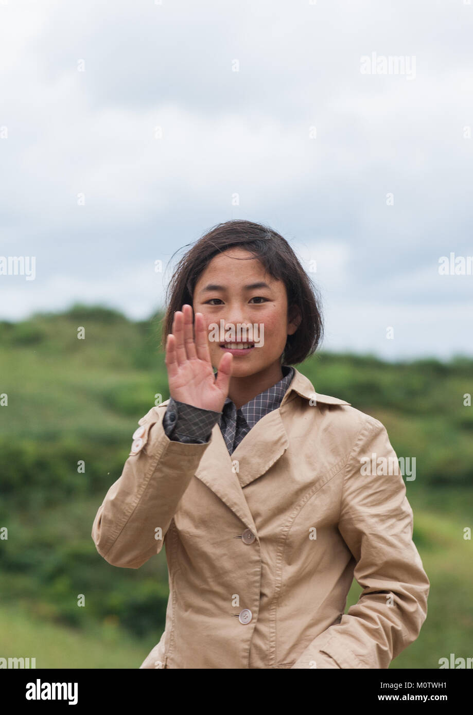 North Korean teenage girl waving hand, North Hamgyong Province, Jung