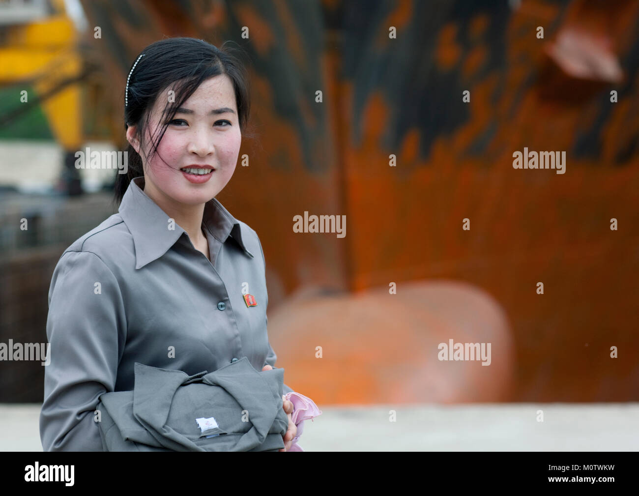 Smiling North Korean woman in a harbour, South Pyongan Province, Nampo, North Korea Stock Photo