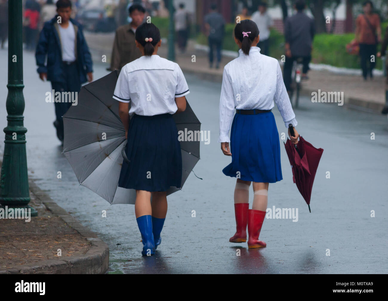 North Korean girls in the street during a rainy day, North Hwanghae ...