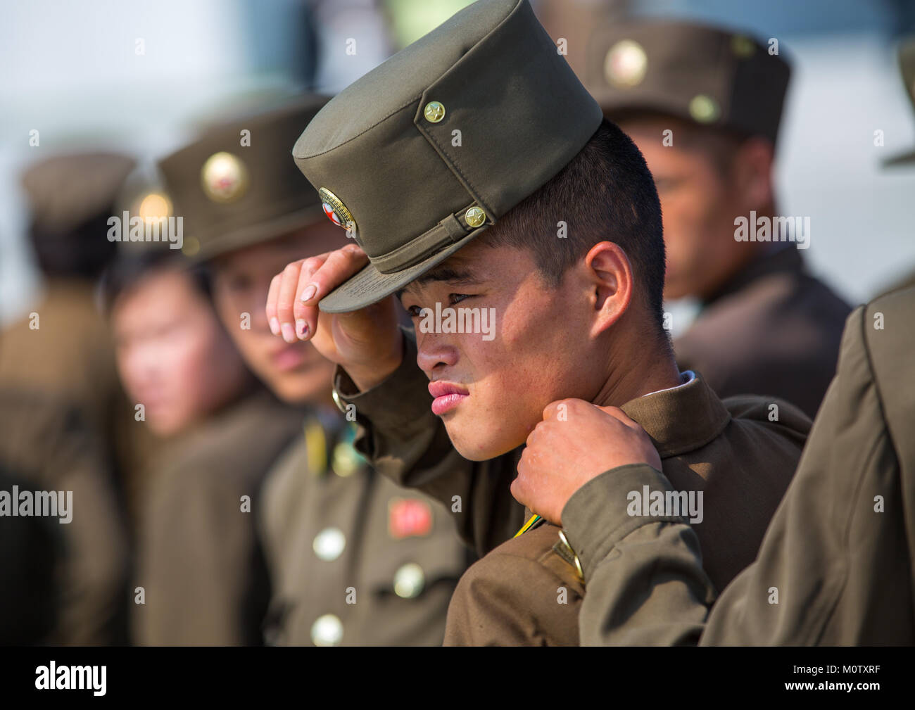 North Korean soldier putting his kepi 