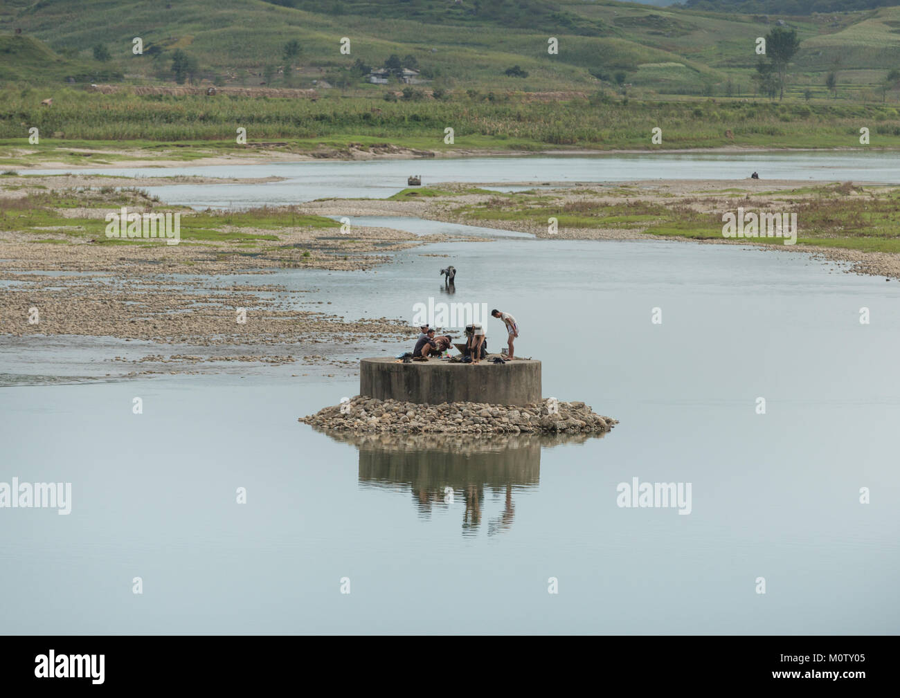 North Korean men having a bath in a river, South Hamgyong Province, Hamhung, North Korea Stock Photo