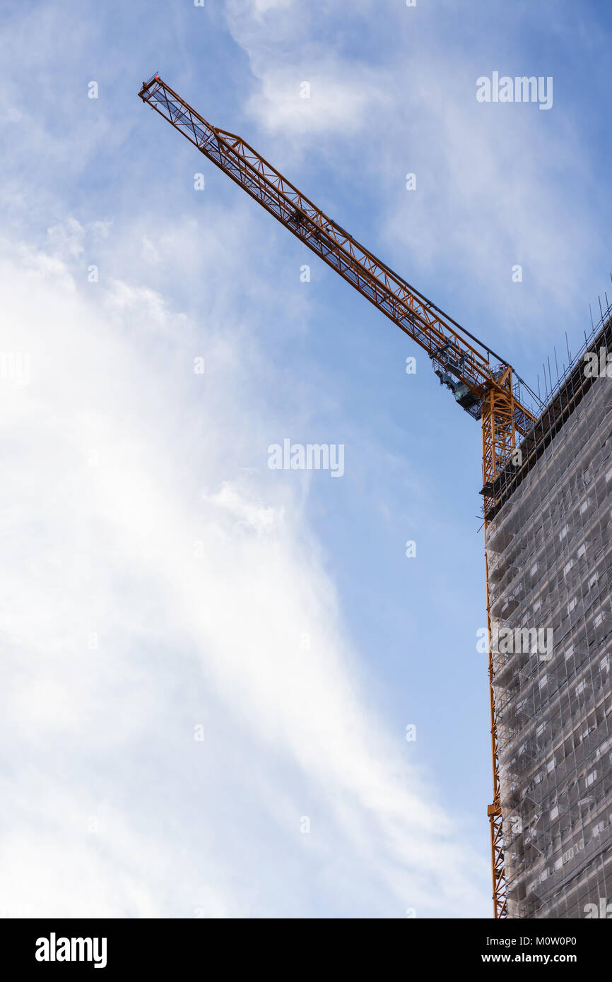 A crane on the top of a block of flats Stock Photo