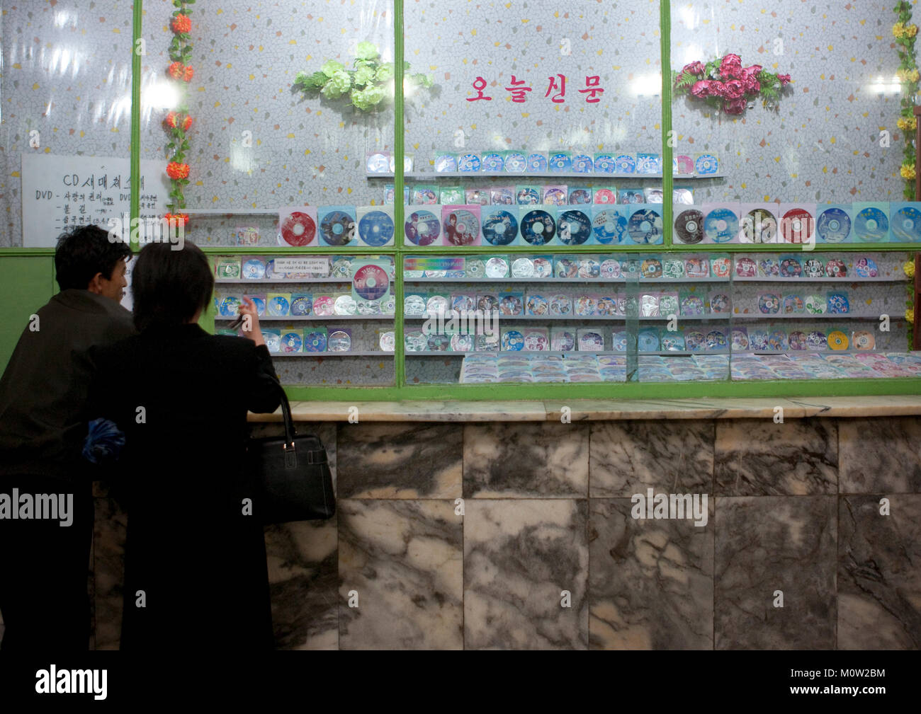 North Korean peiople in front of a dvd and gifts shop inside the subway ...