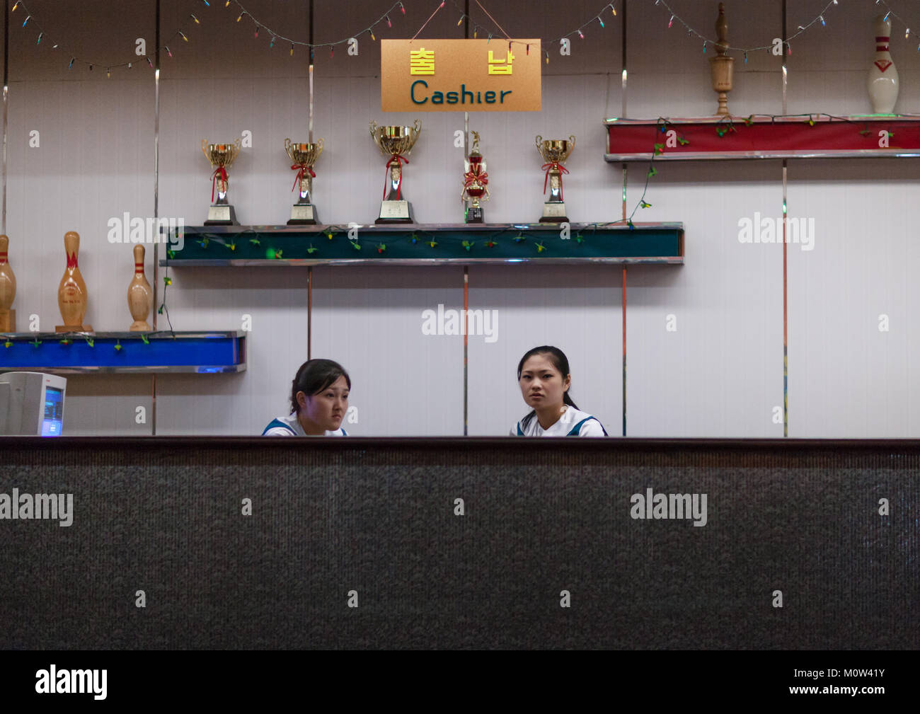 Bowling shoe rental counter with sports trophies, Pyongan Province