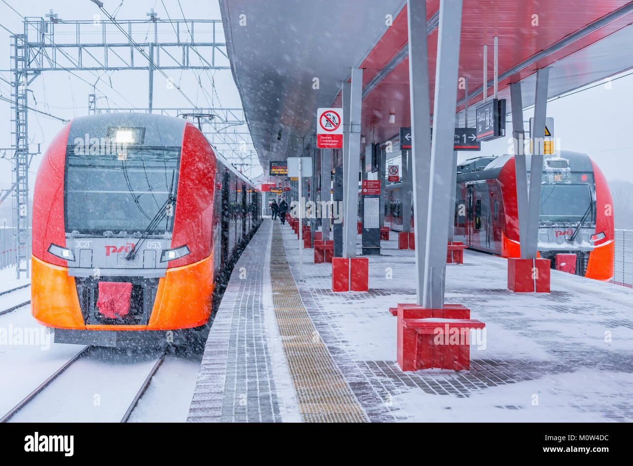Moscow, Russia - January 20, 2018: Highspeed trains stand by the Rostokino station platform at snowstormy day time. Stock Photo
