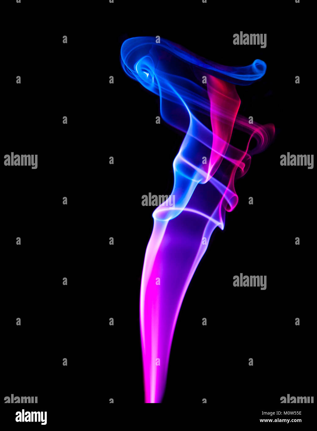 An isolated vertical column of coloured smoke showing red and purple hues having both scientific and artistic appeal as well as black copy space Stock Photo