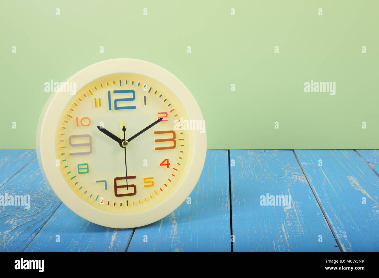 Vintage Alarm Clock Old retro alarm clock on a blue wooden plank and