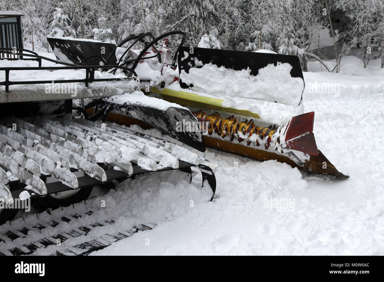 Ratrac. Ratrack, snow grooming machine prepares slopes for skiers on a ski resort in mountains. Ratrac machine for skiing slope preparations in the mo Stock Photo