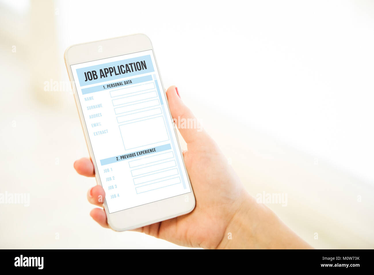 Woman holding a pink gold generic smartphone showing job application Stock Photo