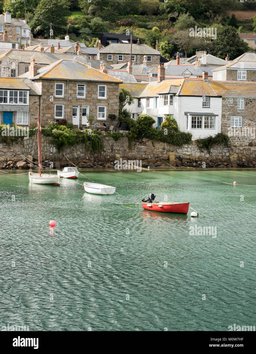 Boats in the harbour of the pretty fishing village of Mousehole in Cornwall, UK Stock Photo