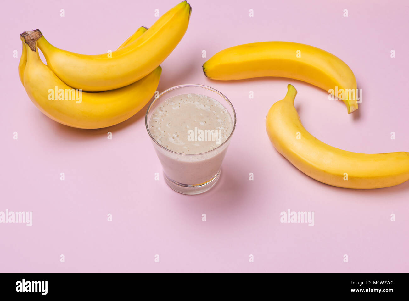 Fresh made Banana smoothie on pink background Stock Photo