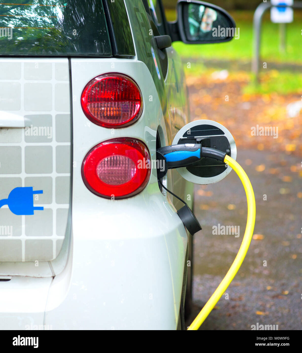 Charging rental electric car on the street Stock Photo Alamy