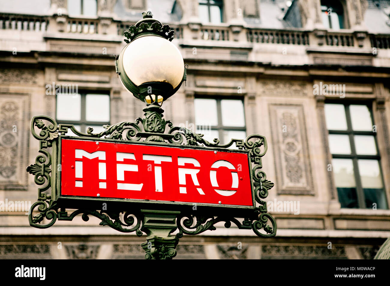 Paris metro sign, subway sign - retro vintage close up, selective focus in front of the belle epoque building. Stock Photo