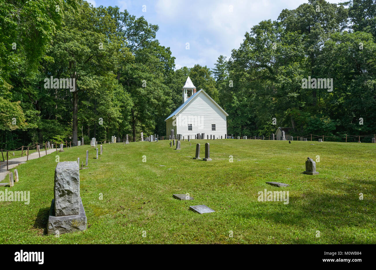 Vintage church, now disused, surrounded by trees and flanked by